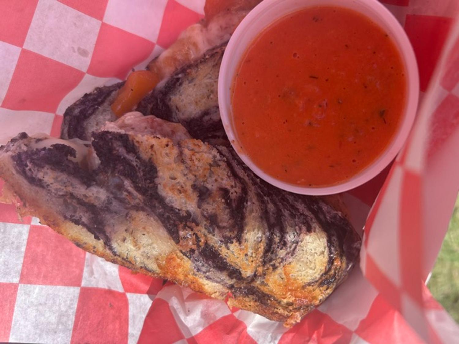 Marble rye grilled cheese served with a cup of fire-roasted tomato basil soup