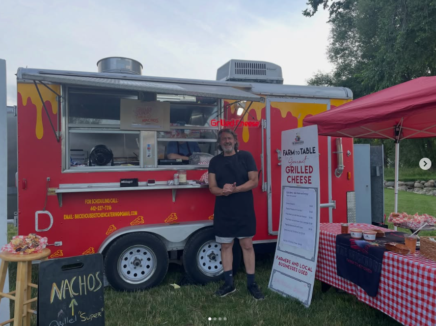 Our team serving gourmet grilled cheese at an outdoor catering event