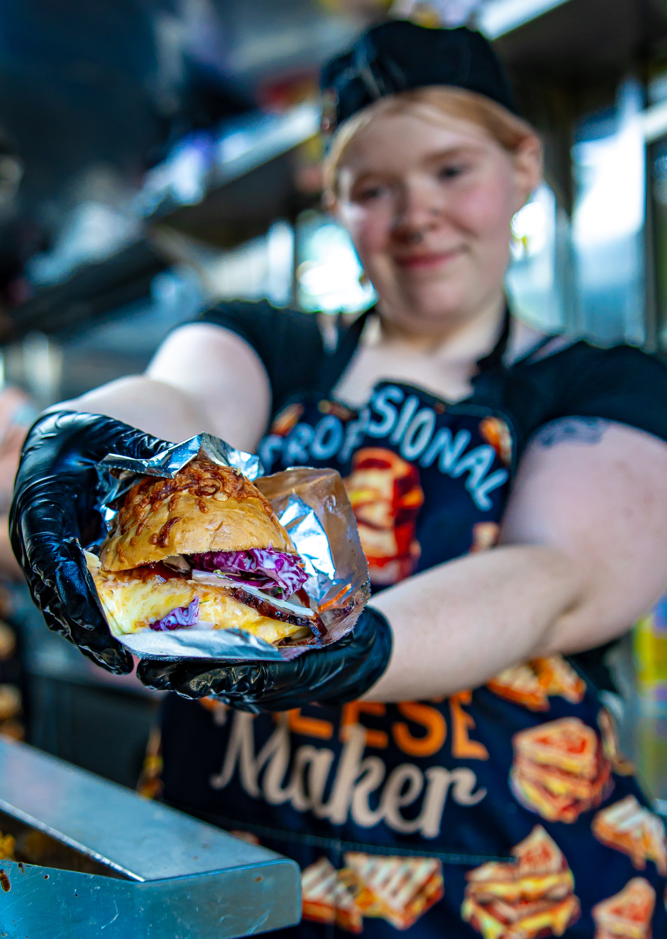 A foil-wrapped BBQ brisket grilled cheese handed out the trailer window